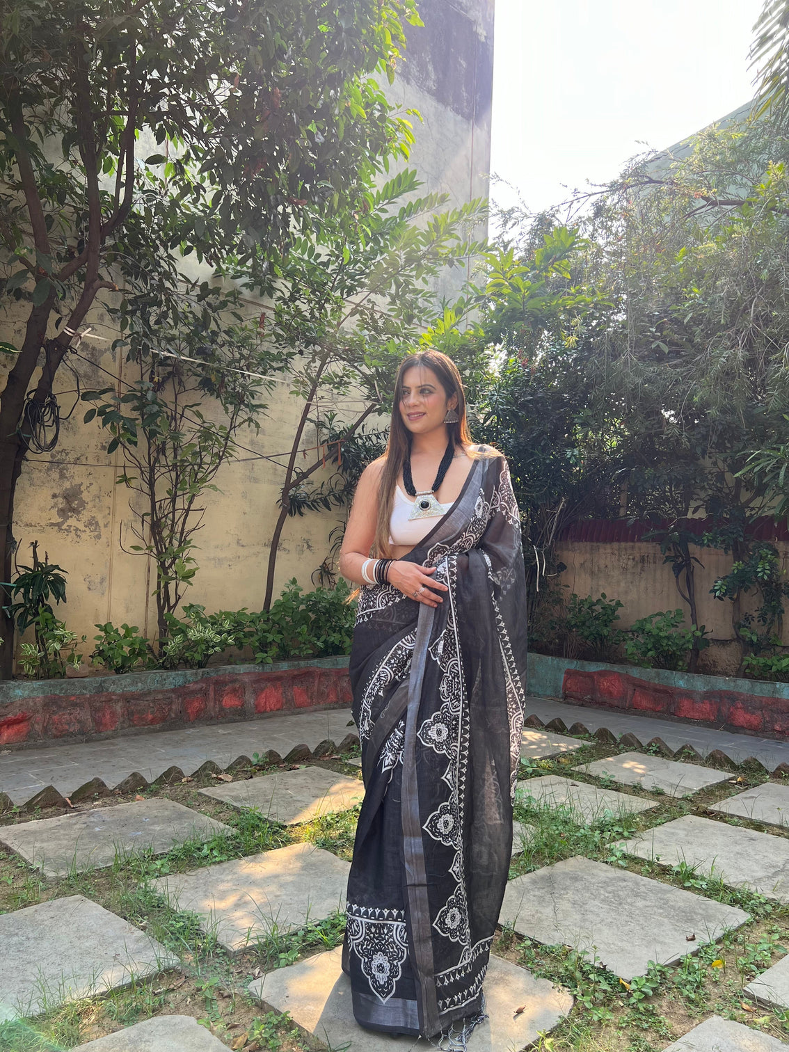 Black and white pure cotton linen saree with intricate floral design and tassels on edges