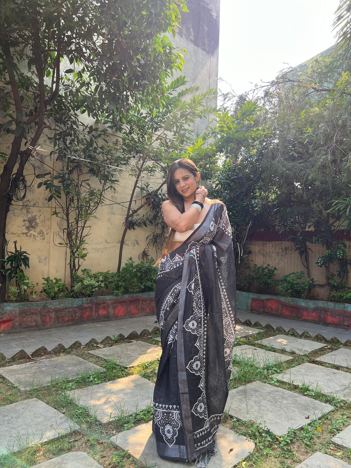 Black and white pure cotton linen saree with intricate floral design and tassels on edges