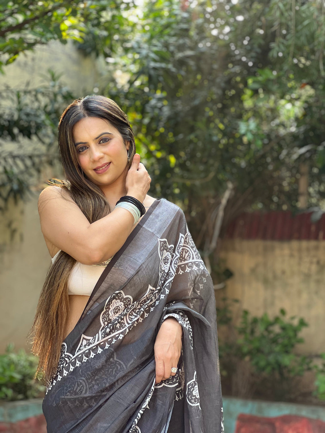 Black and white pure cotton linen saree with intricate floral design and tassels on edges