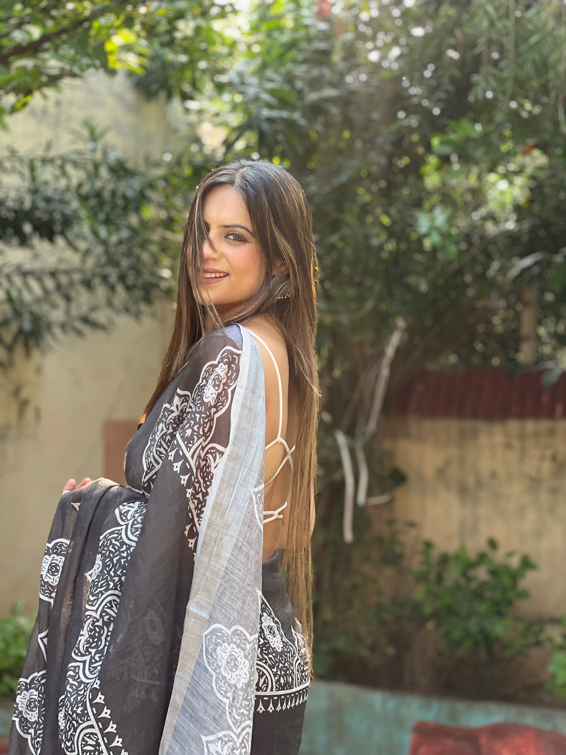 Black and white pure cotton linen saree with intricate floral design and tassels on edges