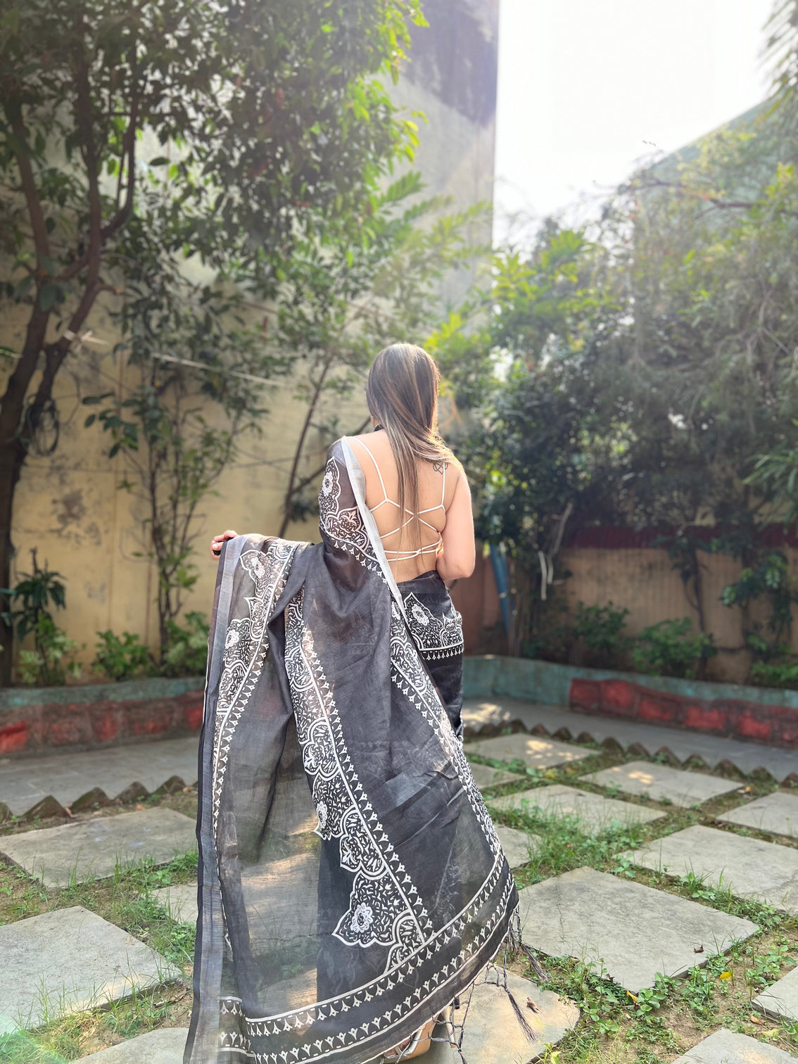 Black and white pure cotton linen saree with intricate floral design and tassels on edges