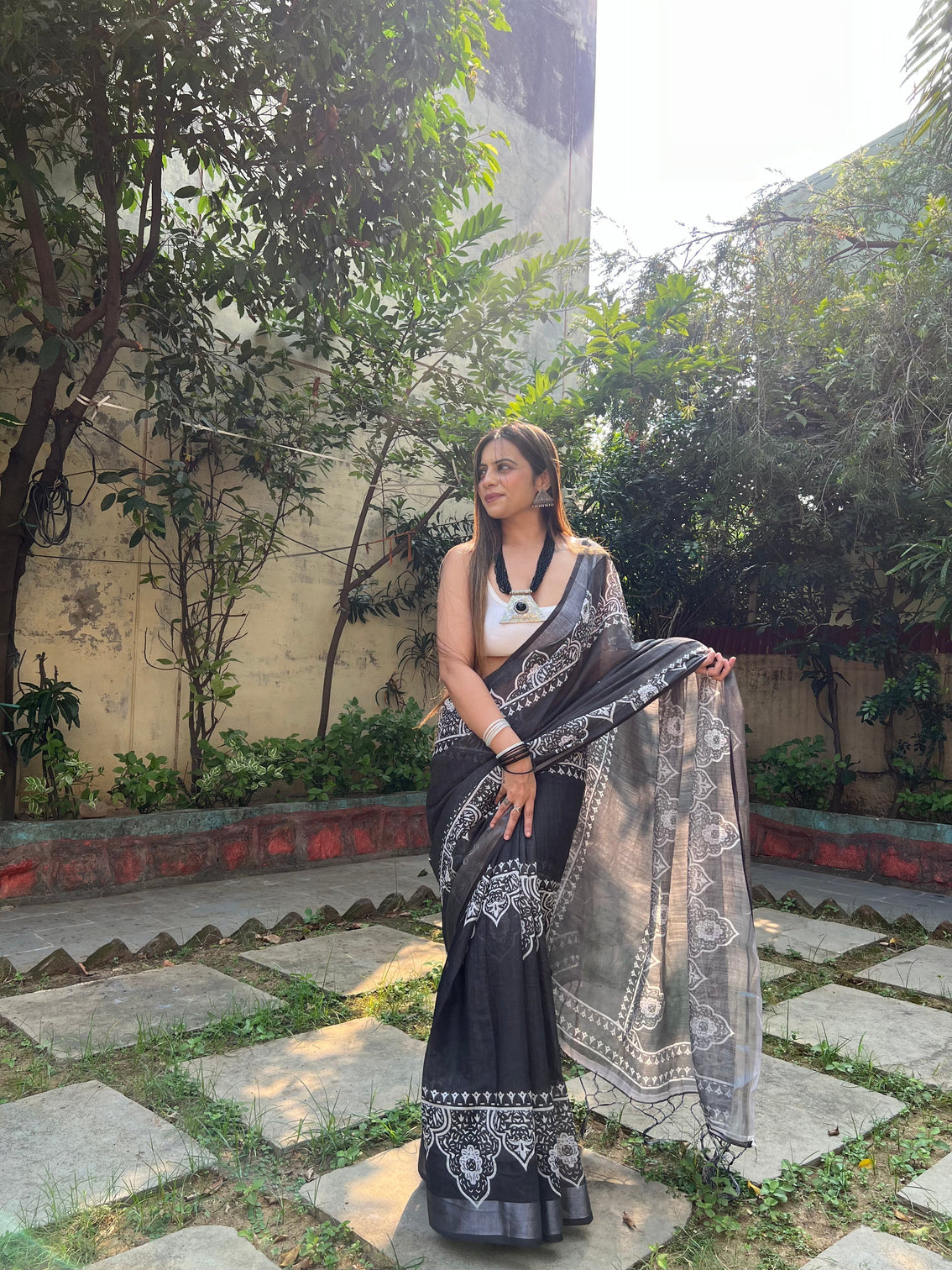 Black and white pure cotton linen saree with intricate floral design and tassels on edges