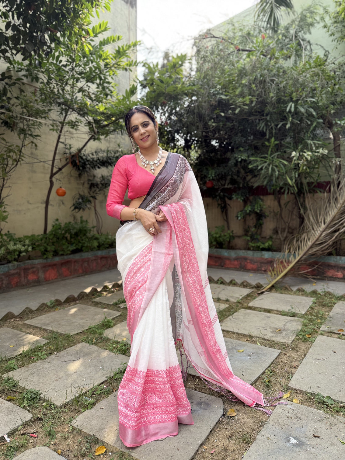 Elegant white and pink pure linen digital printed saree with black border tassels and blouse piece intricate floral and geometric design