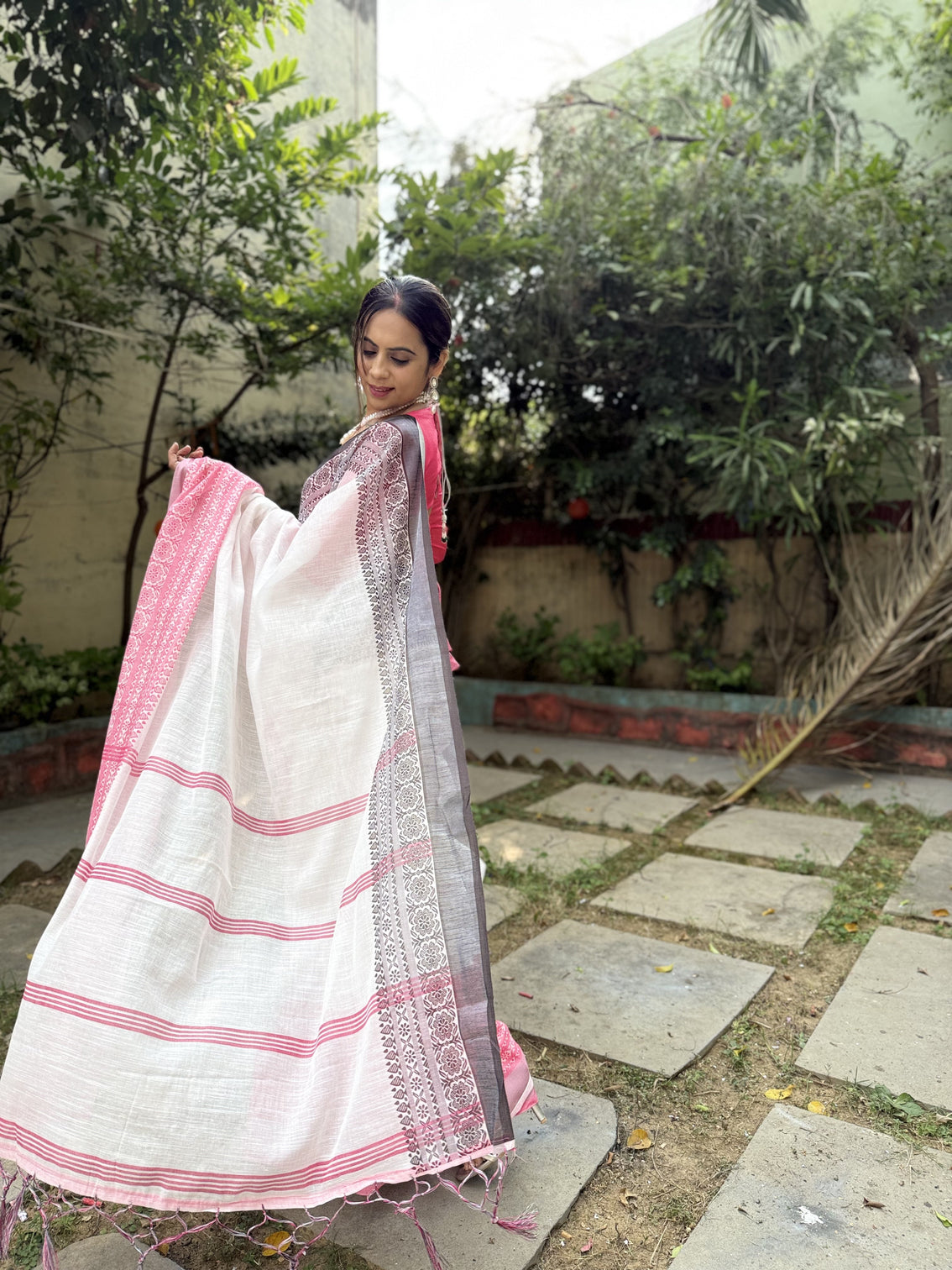 Elegant white and pink pure linen digital printed saree with black border tassels and blouse piece intricate floral and geometric design
