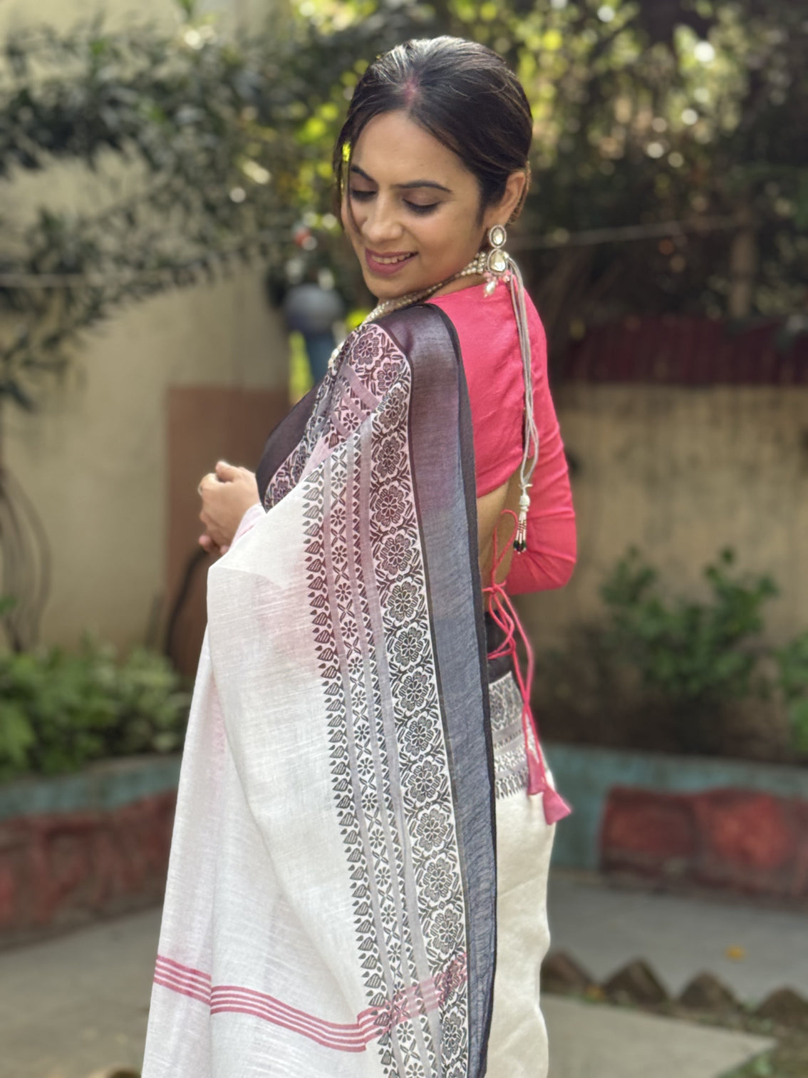 Elegant white and pink pure linen digital printed saree with black border tassels and blouse piece intricate floral and geometric design