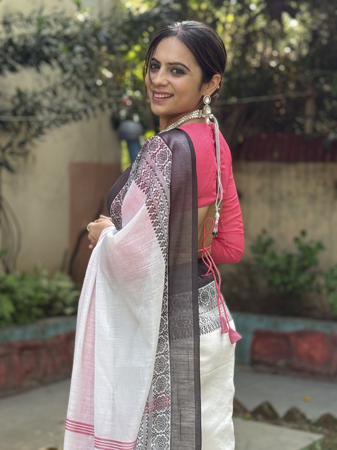Elegant white and pink pure linen digital printed saree with black border tassels and blouse piece intricate floral and geometric design