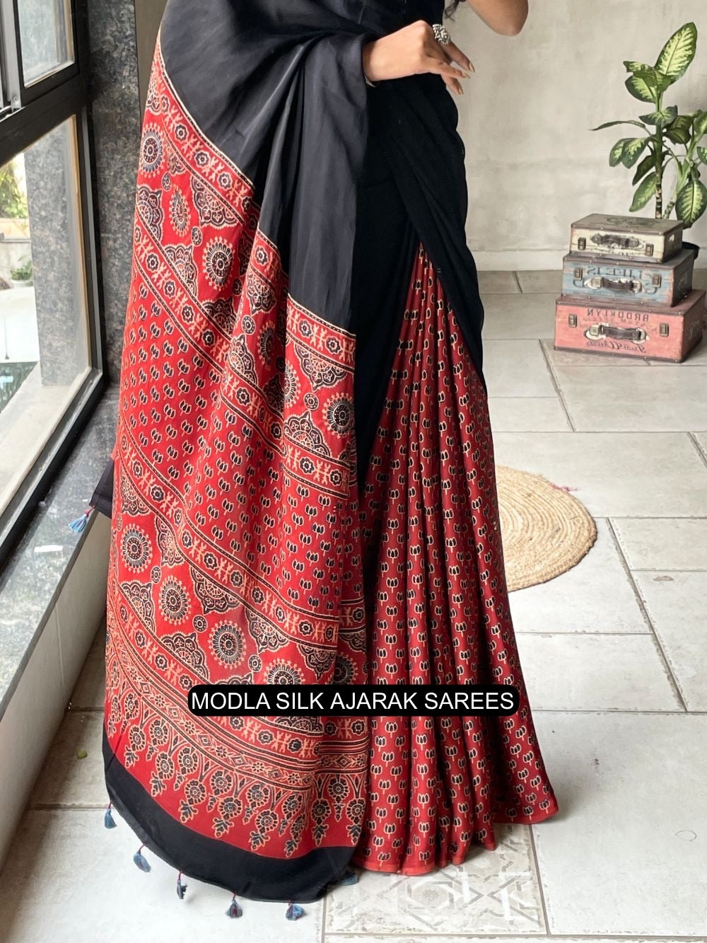 Black red modal silk ajrakh printed saree with heritage border traditional pallu tassel detailing