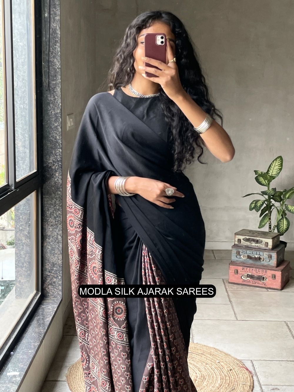 Black modal silk ajrakh printed saree with traditional heritage pallu intricate ethnic motifs tassel detailing