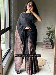 Black modal silk ajrakh printed saree with traditional heritage pallu intricate ethnic motifs tassel detailing mameraa