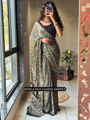Black modal silk ajrakh printed saree with heritage geometric motifs traditional border artistic ethnic pallu mameraa