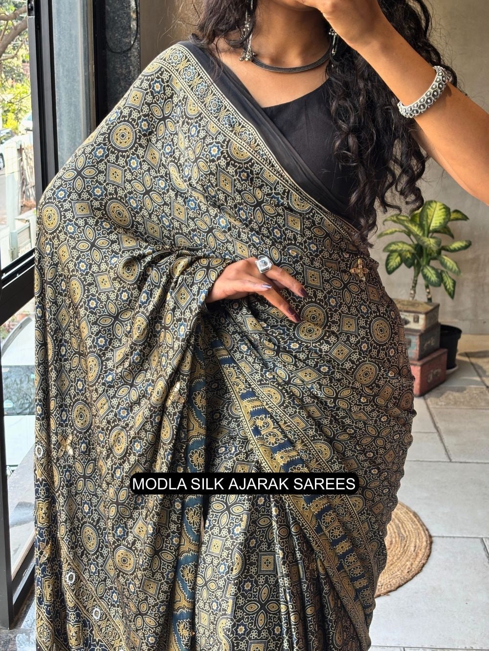 Black modal silk ajrakh printed saree with heritage geometric motifs traditional border artistic ethnic pallu