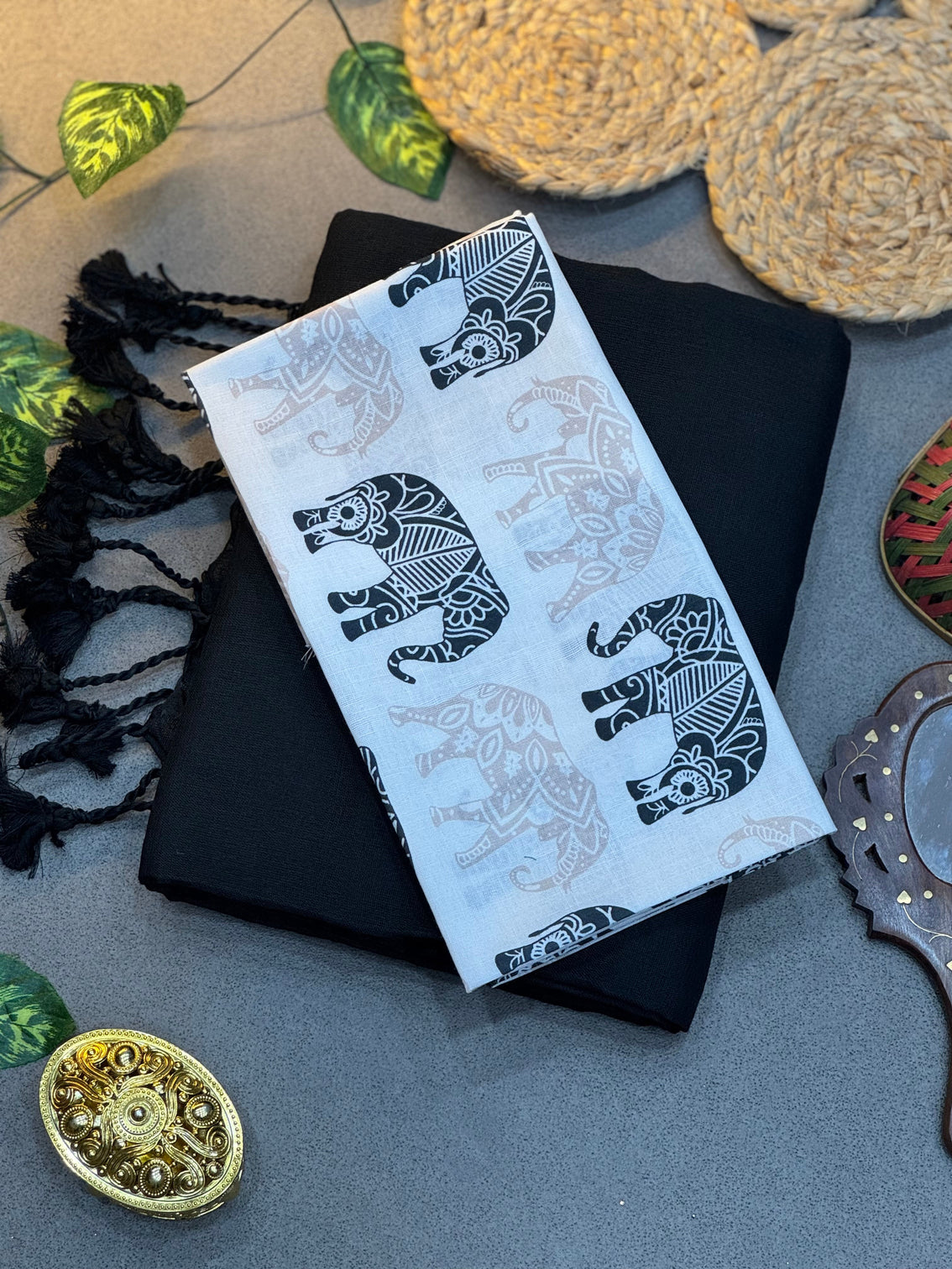 Handwoven black khadi cotton saree paired with elephant motif digital printed blouse mameraa