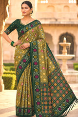 Engaging Green Patola Silk Saree with Smart Blouse Piece