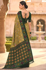 Engaging Green Patola Silk Saree with Smart Blouse Piece
