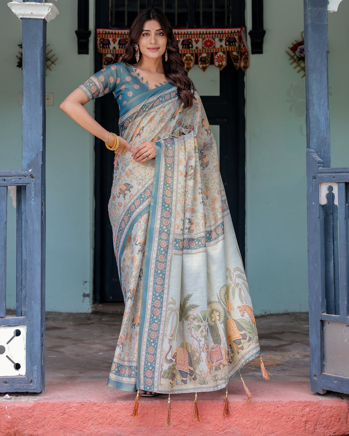 Icy blue handloom cotton saree with peach elephant motifs royal procession pallu