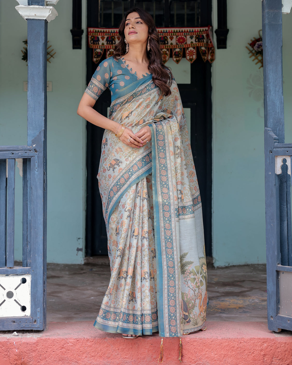 Icy blue handloom cotton saree with peach elephant motifs royal procession pallu
