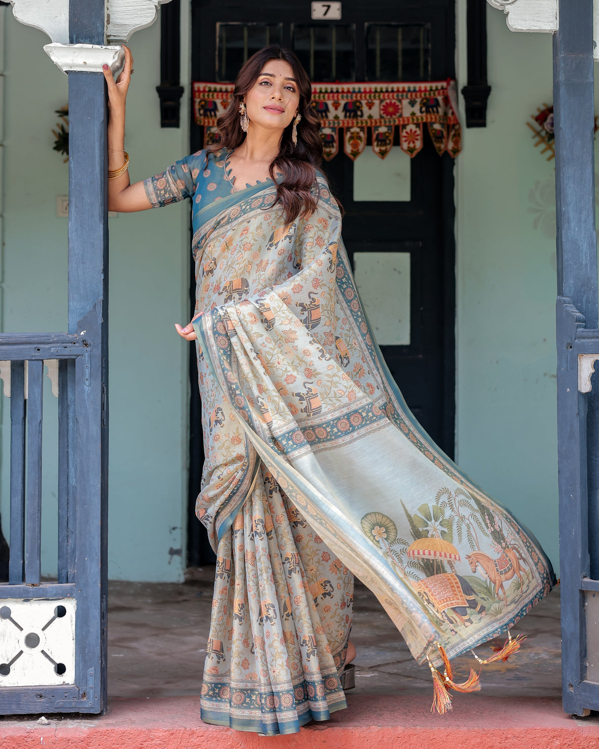 Icy blue handloom cotton saree with peach elephant motifs royal procession pallu