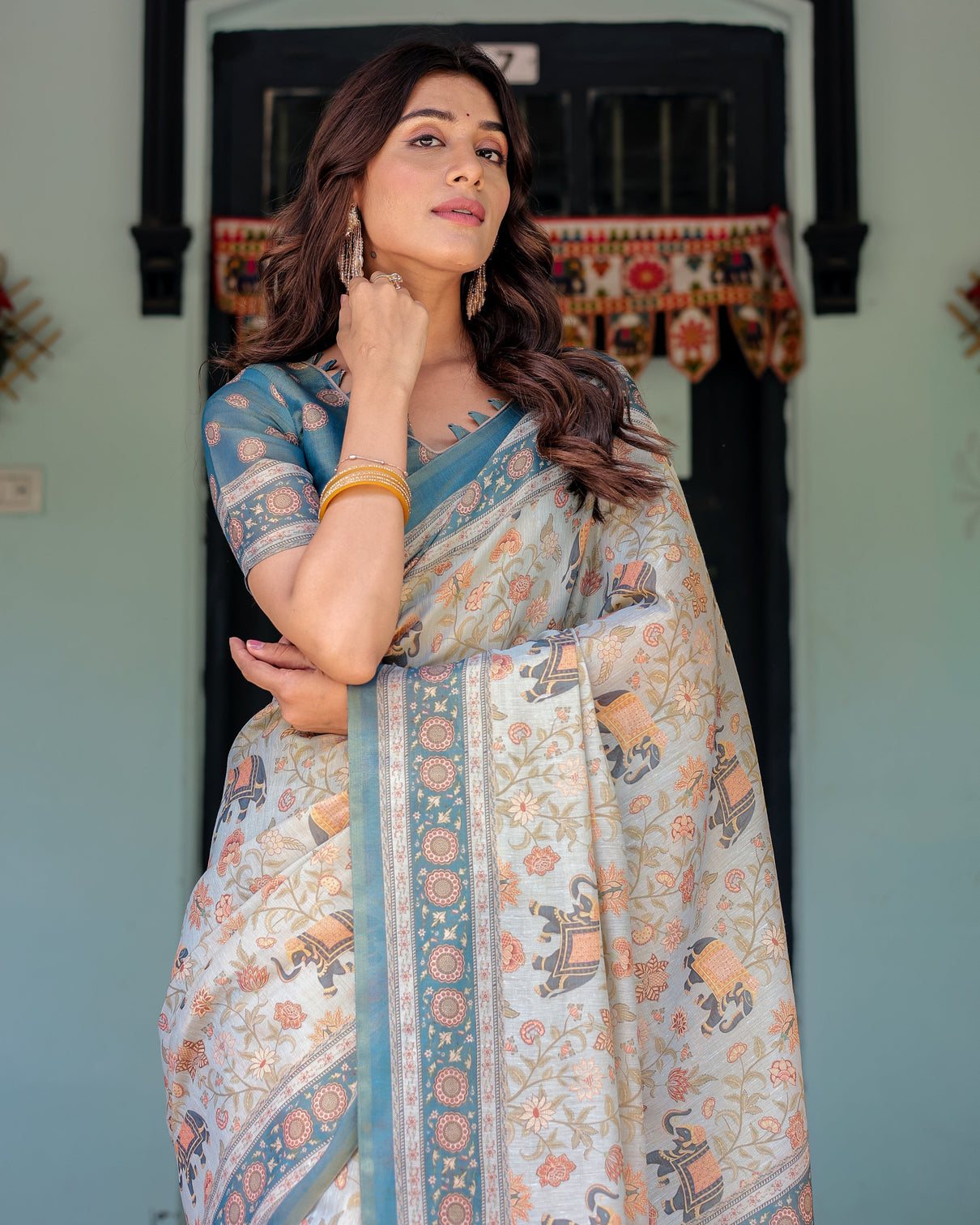 Icy blue handloom cotton saree with peach elephant motifs royal procession pallu