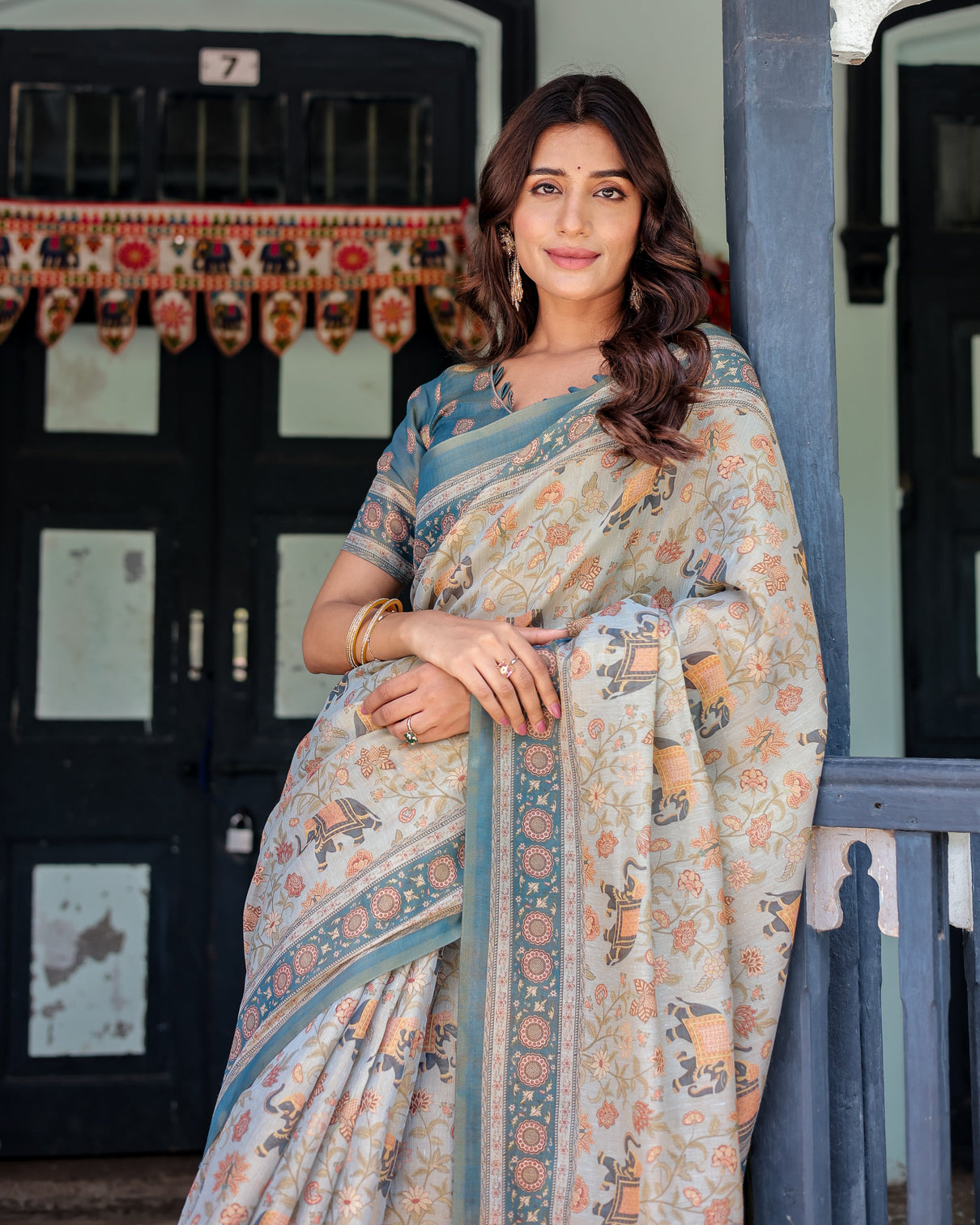 Icy blue handloom cotton saree with peach elephant motifs royal procession pallu