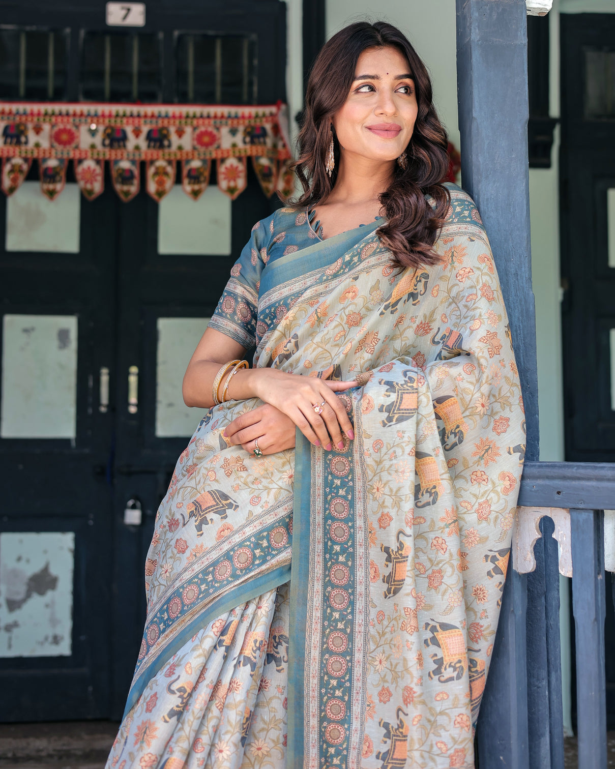Icy blue handloom cotton saree with peach elephant motifs royal procession pallu