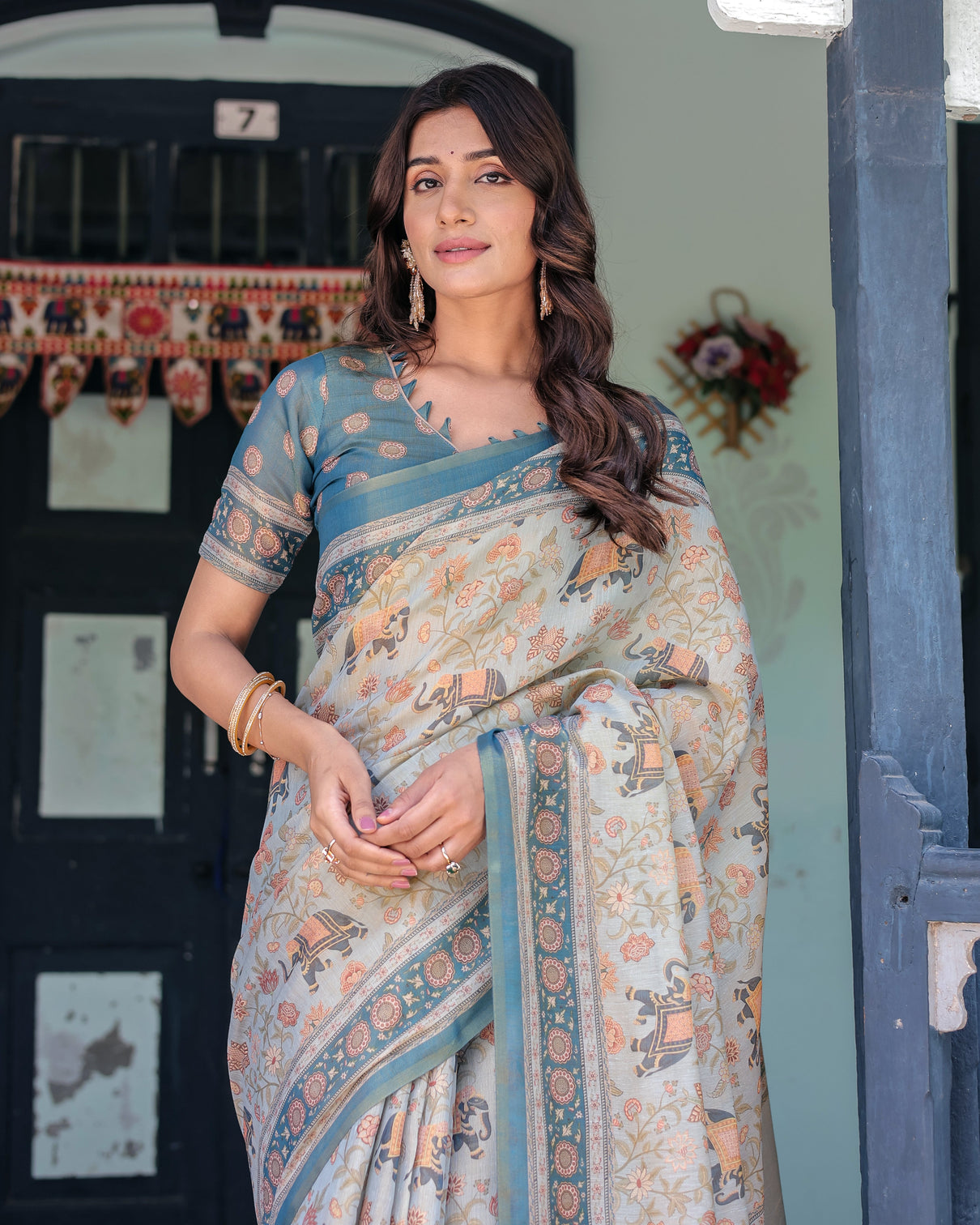 Icy blue handloom cotton saree with peach elephant motifs royal procession pallu