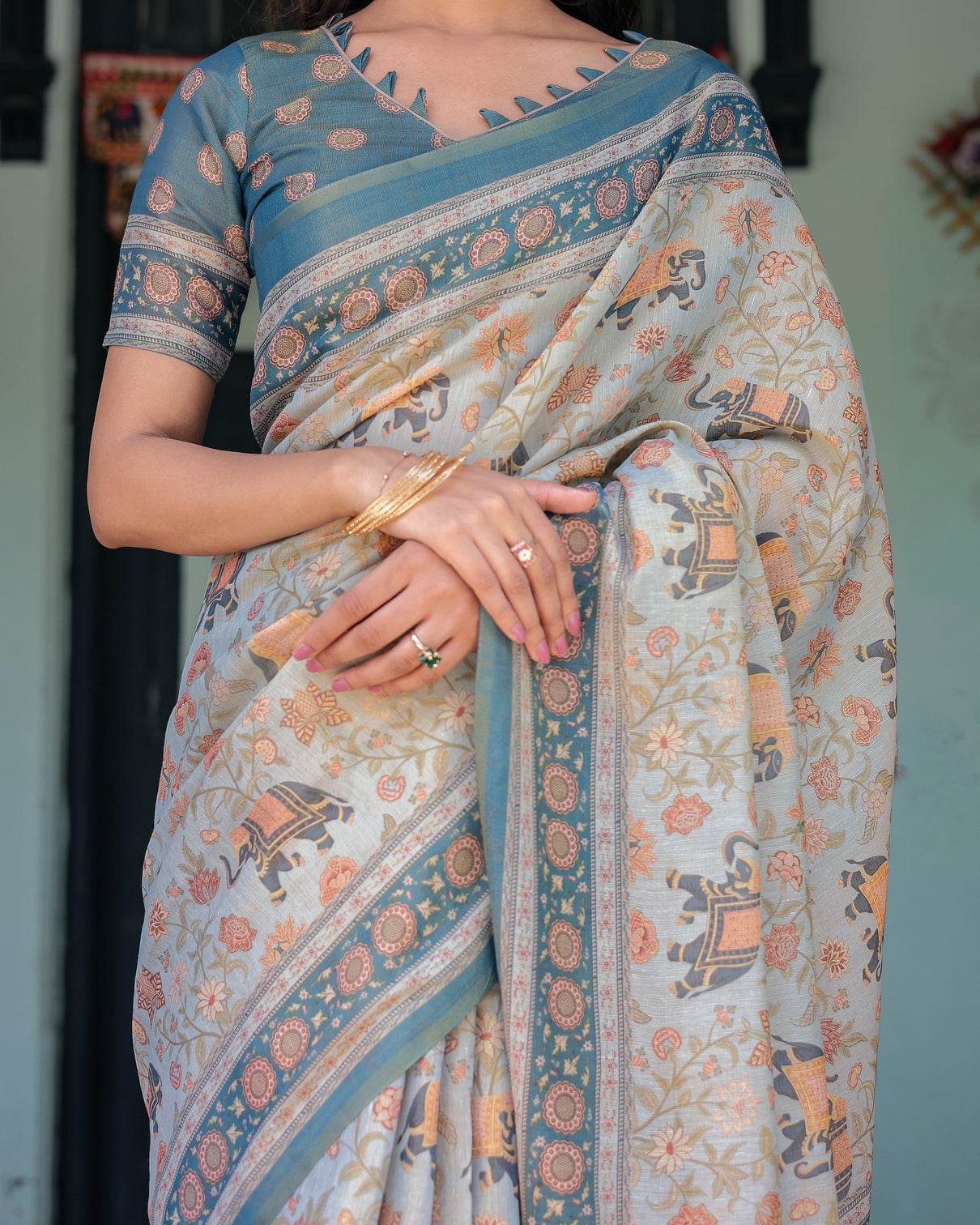 Icy blue handloom cotton saree with peach elephant motifs royal procession pallu