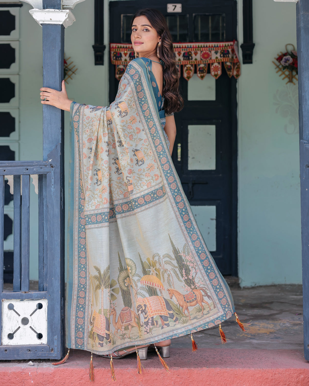Icy blue handloom cotton saree with peach elephant motifs royal procession pallu