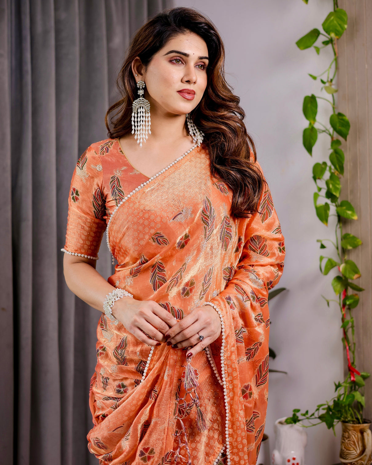 Sunset orange fendy chiffon saree with foil block print tassel detail pearl border