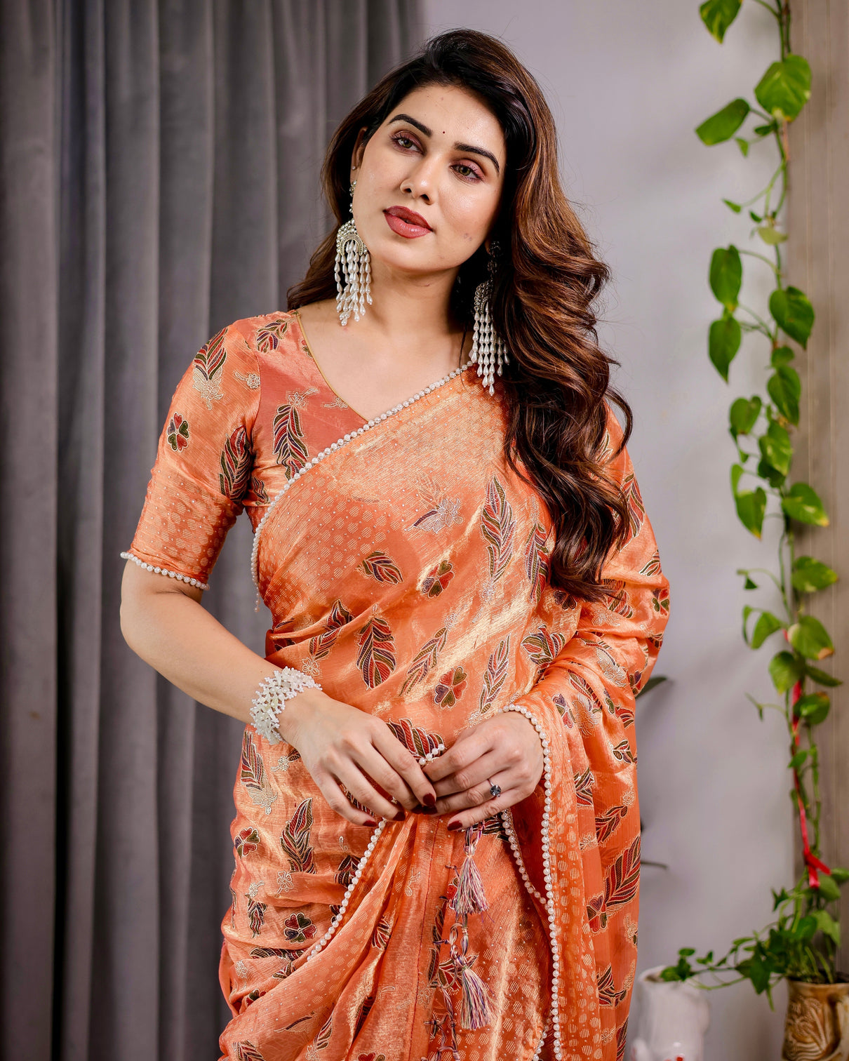 Sunset orange fendy chiffon saree with foil block print tassel detail pearl border