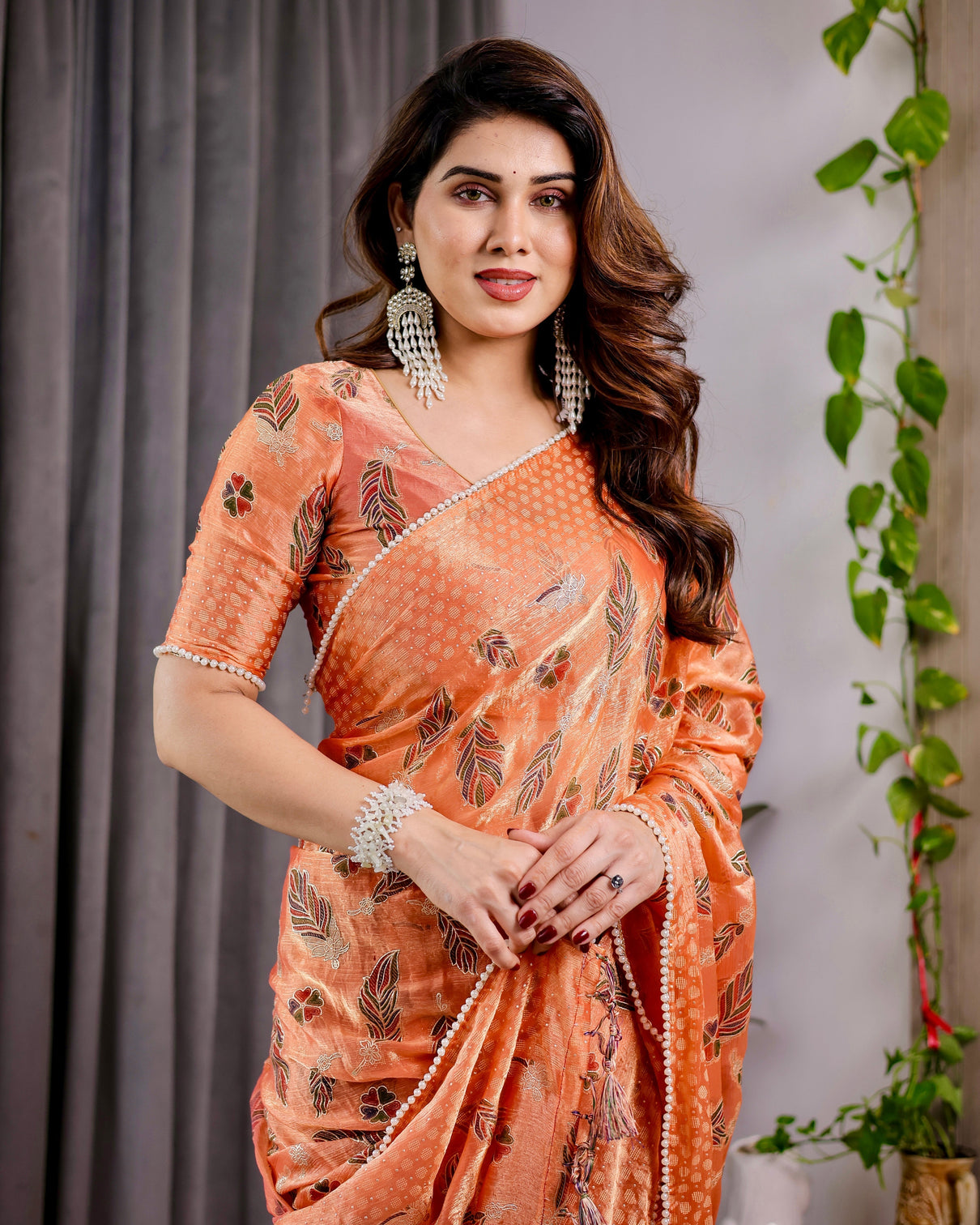 Sunset orange fendy chiffon saree with foil block print tassel detail pearl border