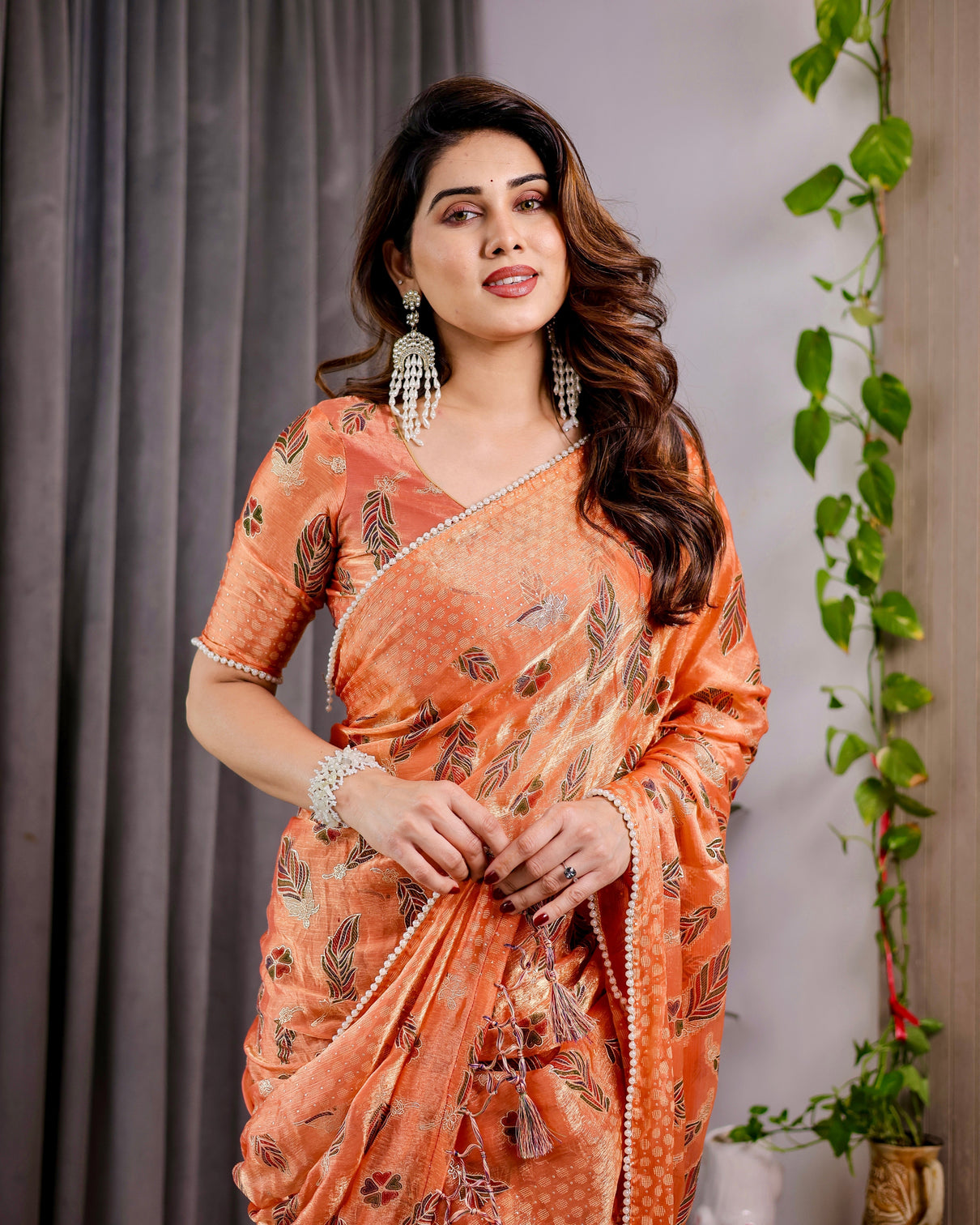 Sunset orange fendy chiffon saree with foil block print tassel detail pearl border