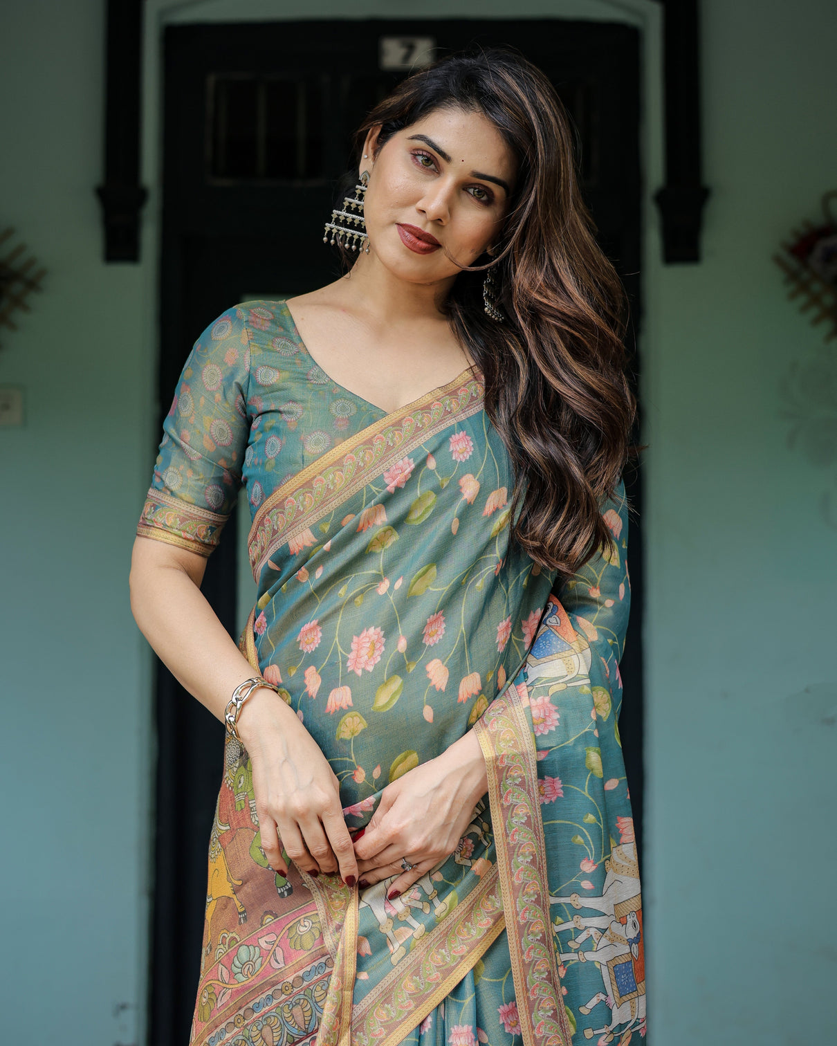 Divine procession teal green handloom cotton saree with lotus floral print artistic pallu