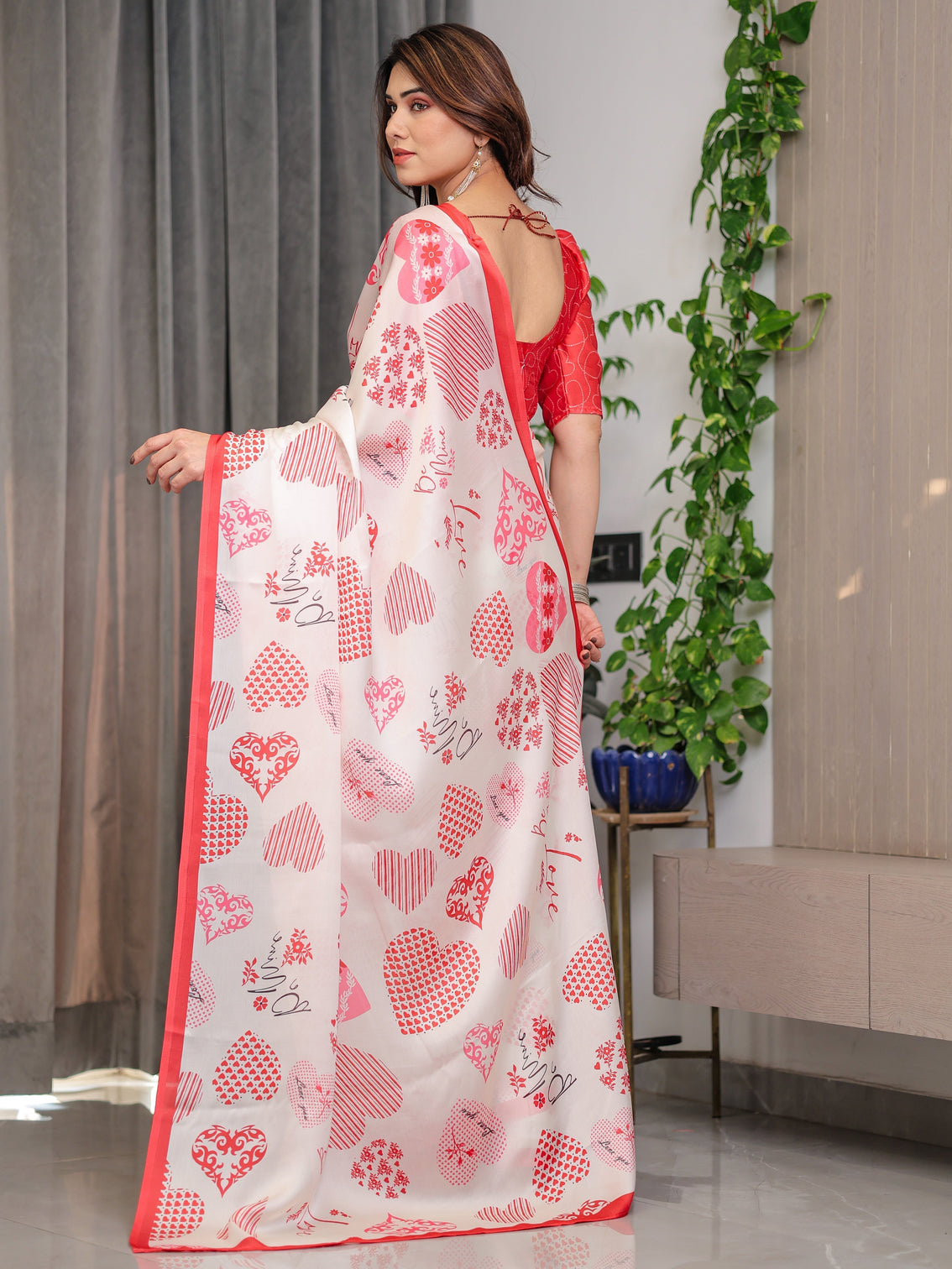 Ivory pink red love themed satin georgette saree with heart prints and romantic pallu attached blouse