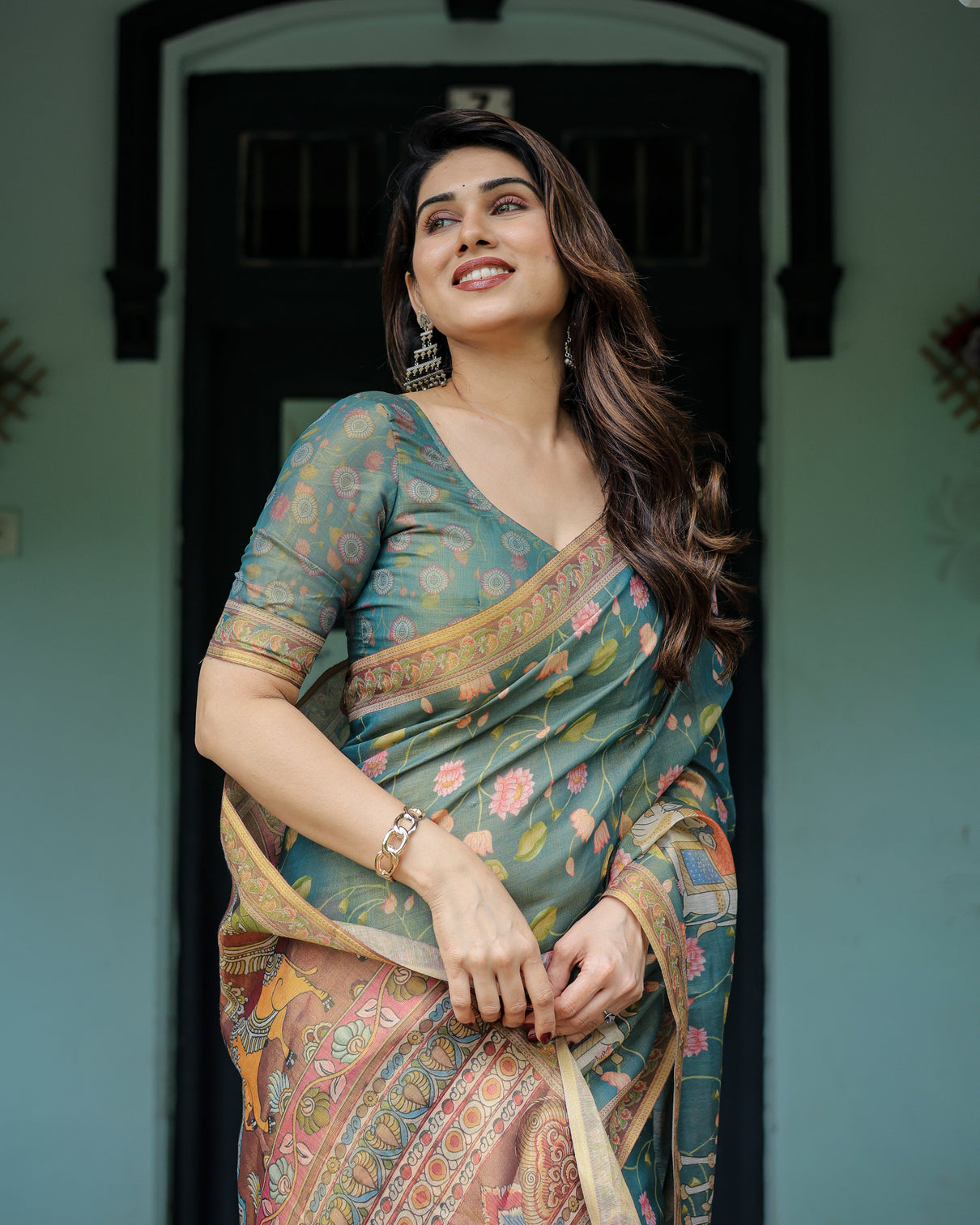 Divine procession teal green handloom cotton saree with lotus floral print artistic pallu