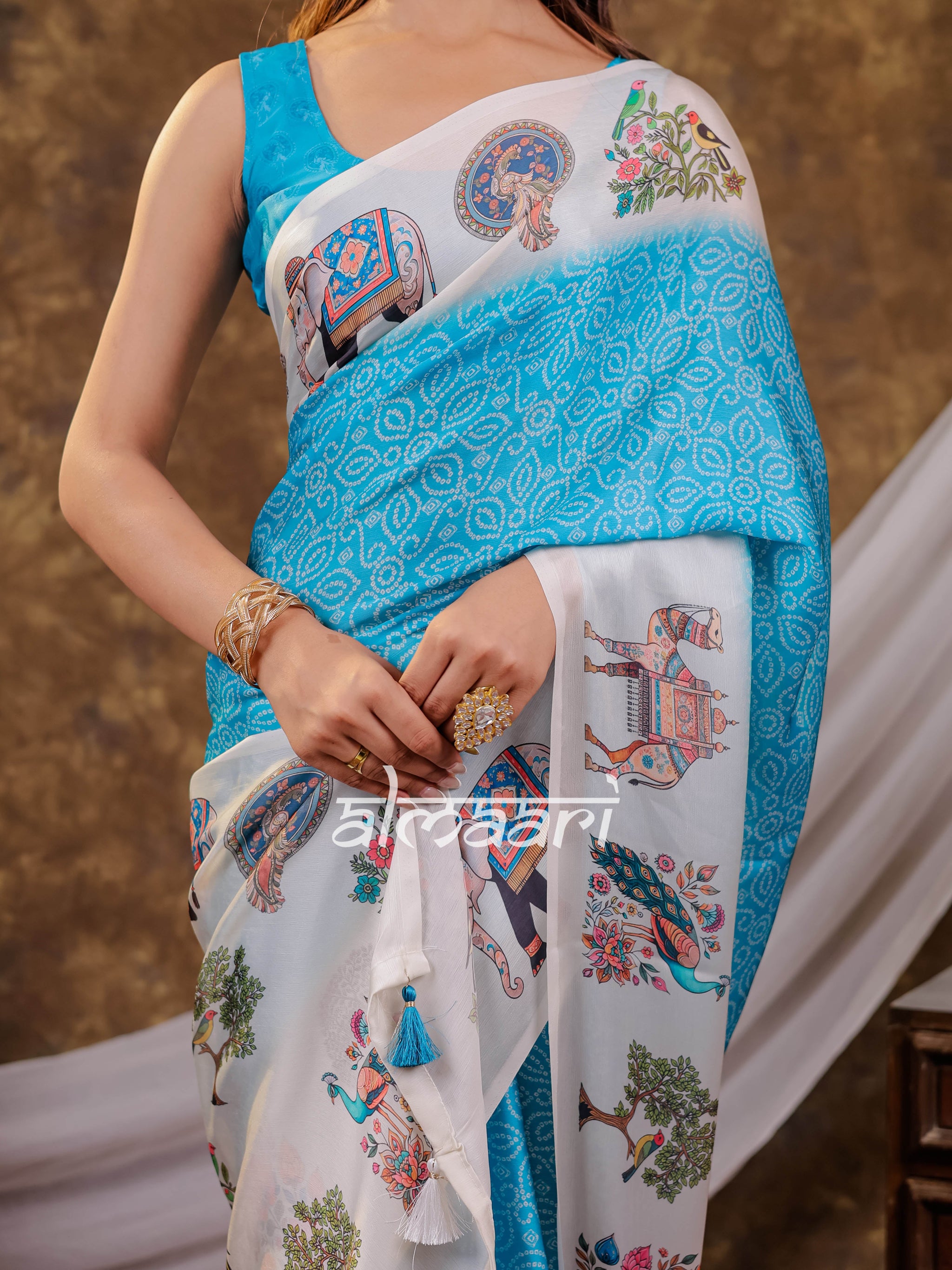 Vantara Turquoise Blue Satin Chiffon Printed Saree with Elephant & Peacock Heritage Print, Designer Tassel Pallu & Matching Blouse Piece