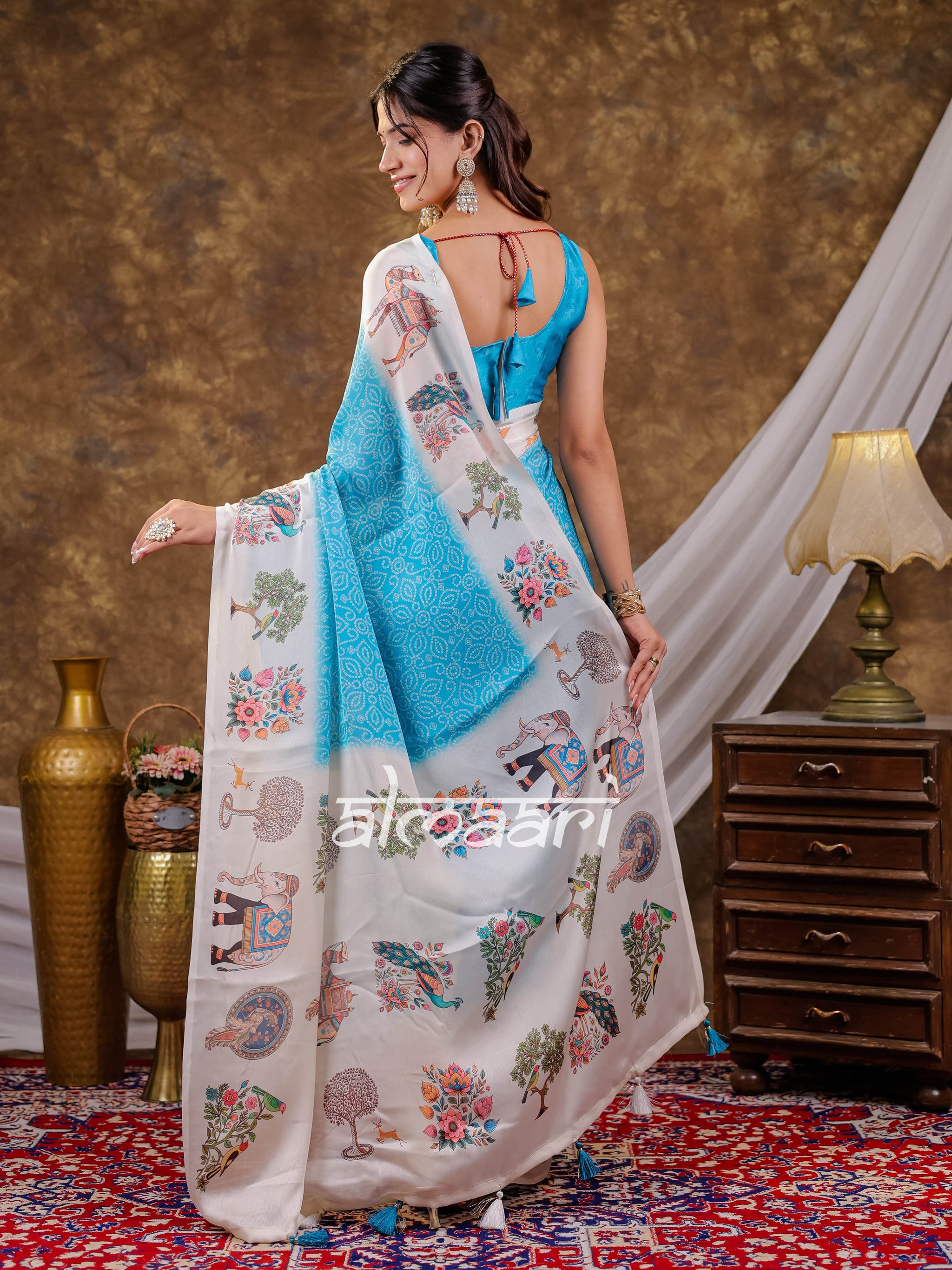 Vantara Turquoise Blue Satin Chiffon Printed Saree with Elephant & Peacock Heritage Print, Designer Tassel Pallu & Matching Blouse Piece