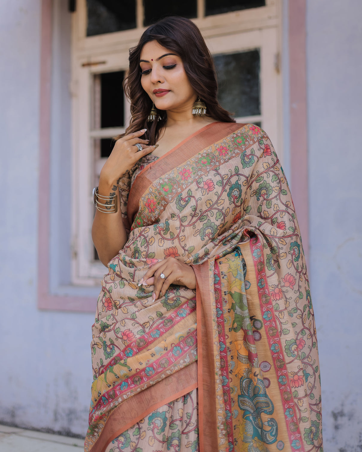 Handwoven beige peach saree with beautiful border detailing a timeless indian classic