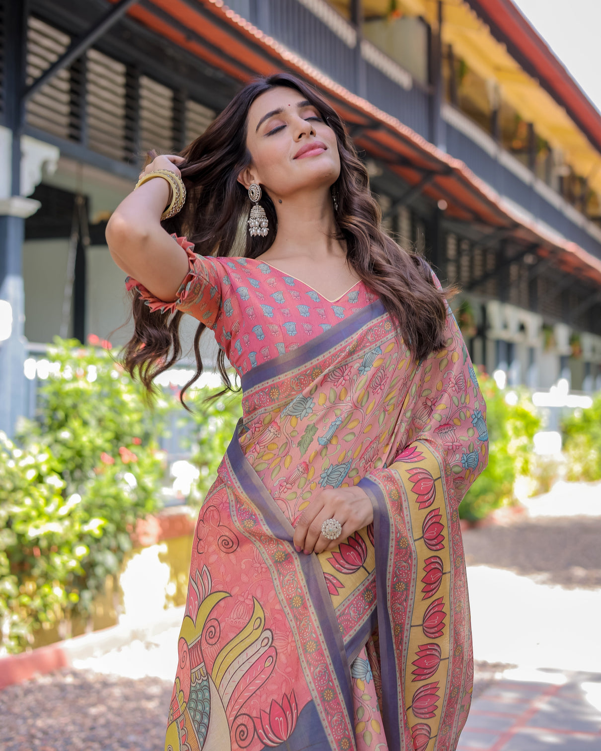 Peach pink handloom cotton saree with lotus bird motifs and navy border pallu