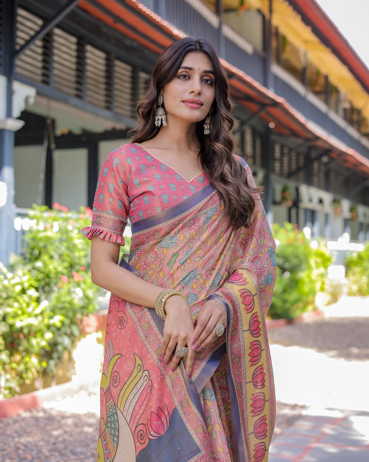 Peach pink handloom cotton saree with lotus bird motifs and navy border pallu