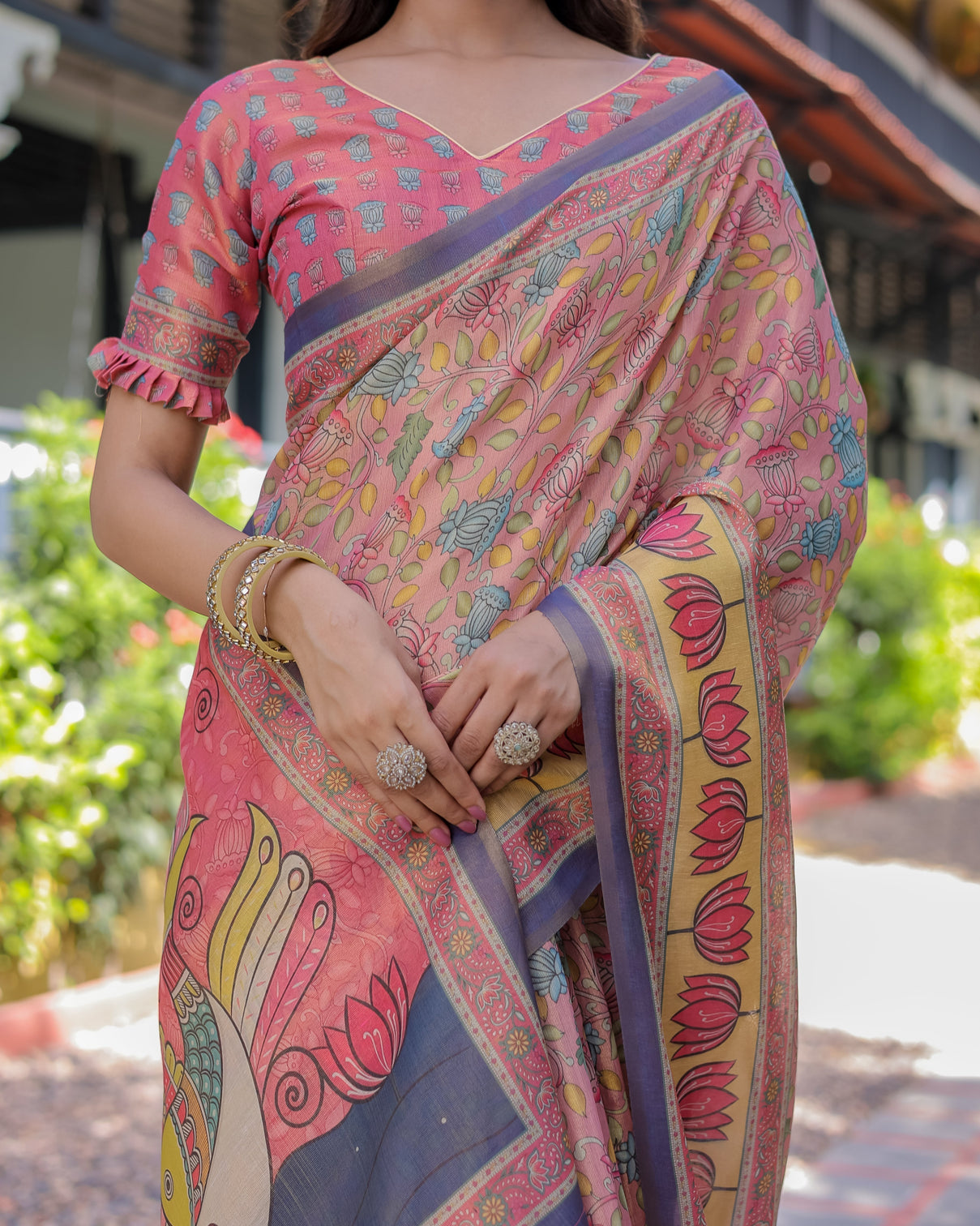 Peach pink handloom cotton saree with lotus bird motifs and navy border pallu
