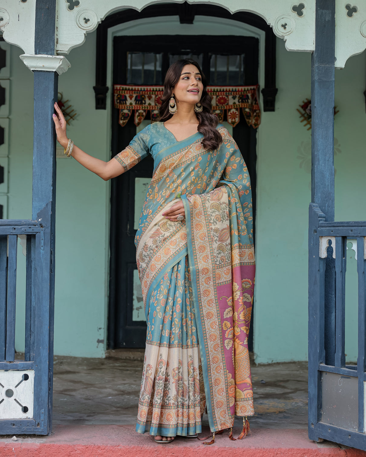 Turquoise blue handloom cotton saree with multicolor floral pallu peach border