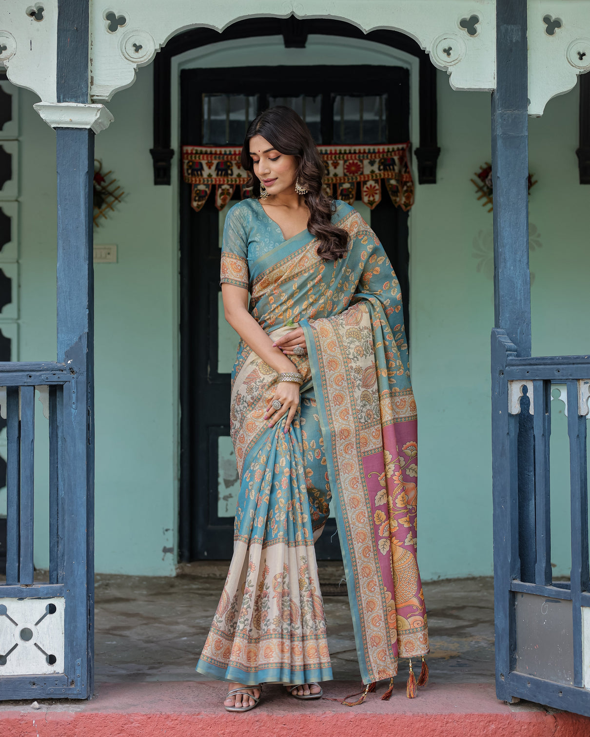 Turquoise blue handloom cotton saree with multicolor floral pallu peach border