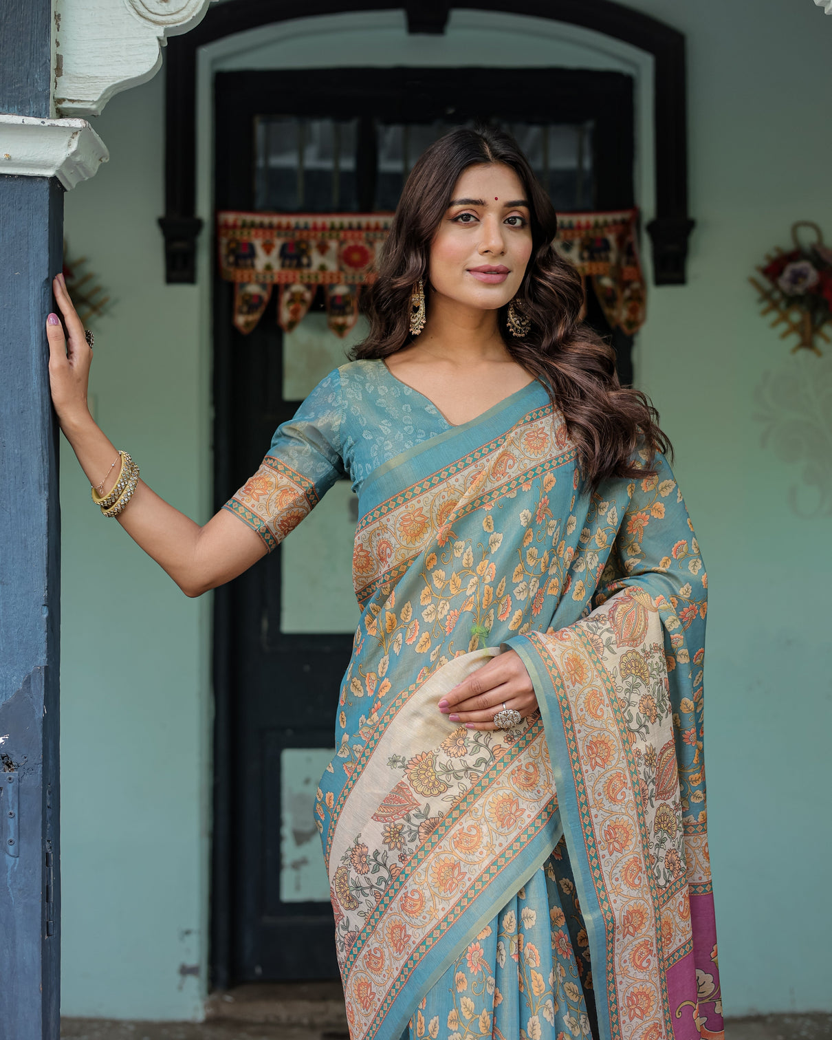 Turquoise blue handloom cotton saree with multicolor floral pallu peach border