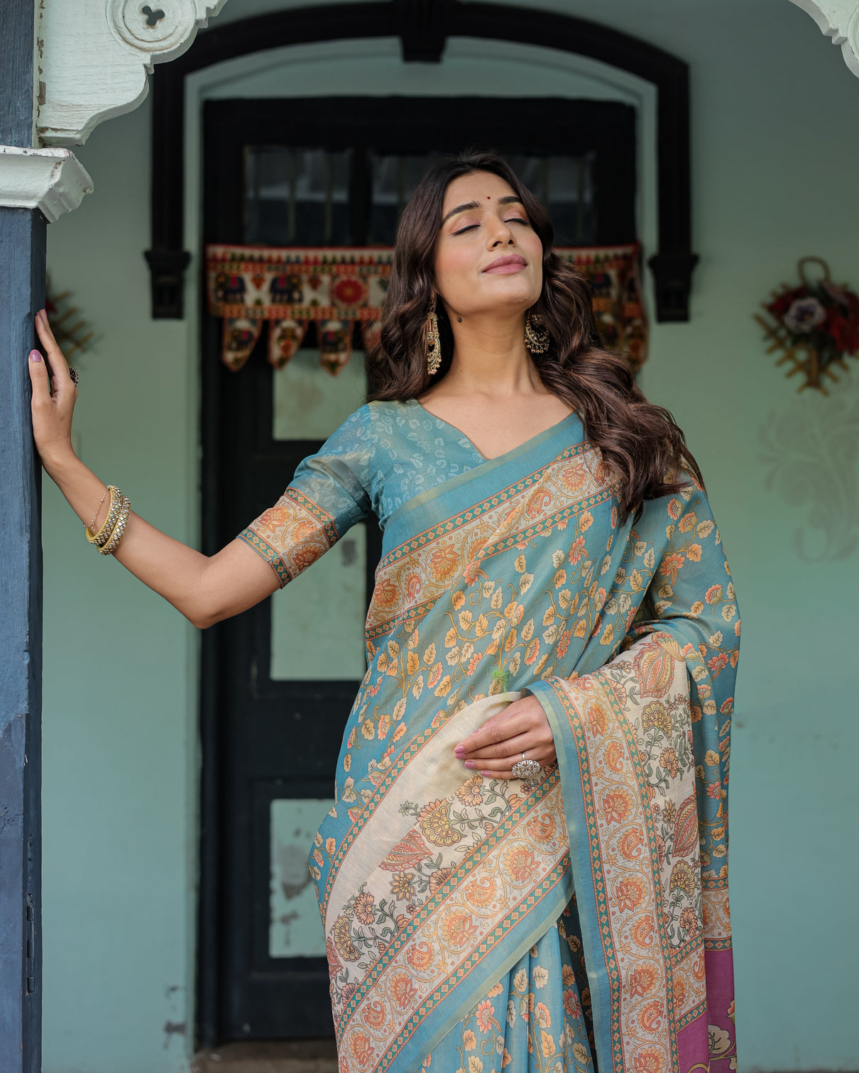 Turquoise blue handloom cotton saree with multicolor floral pallu peach border