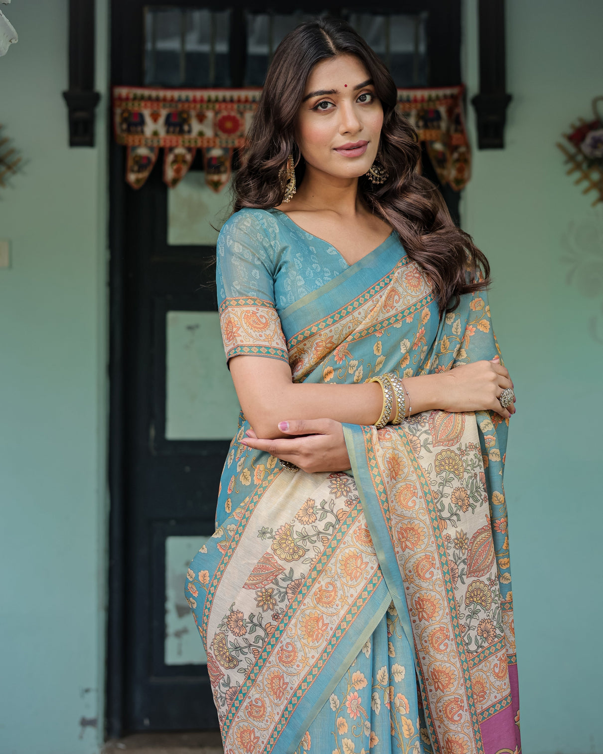 Turquoise blue handloom cotton saree with multicolor floral pallu peach border