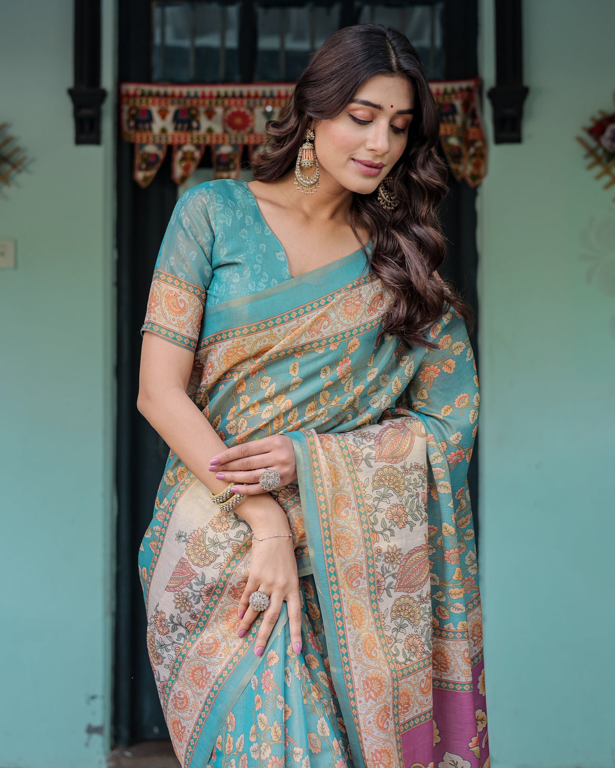 Turquoise blue handloom cotton saree with multicolor floral pallu peach border