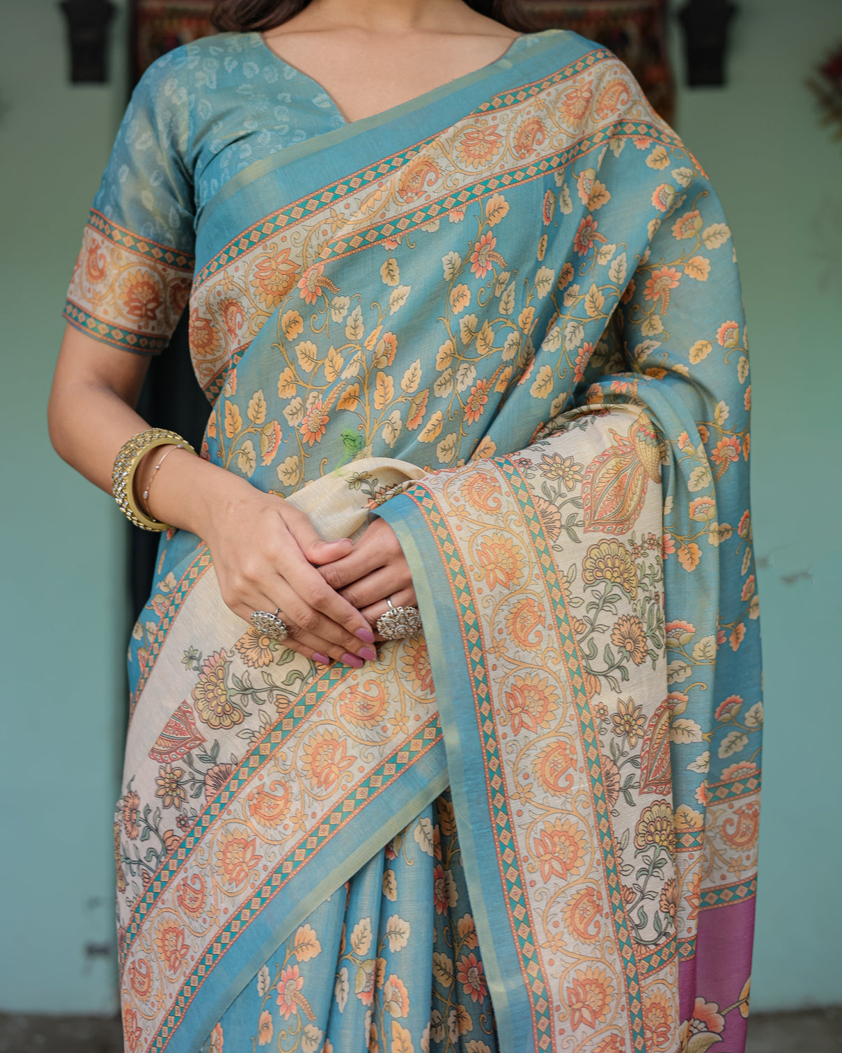 Turquoise blue handloom cotton saree with multicolor floral pallu peach border