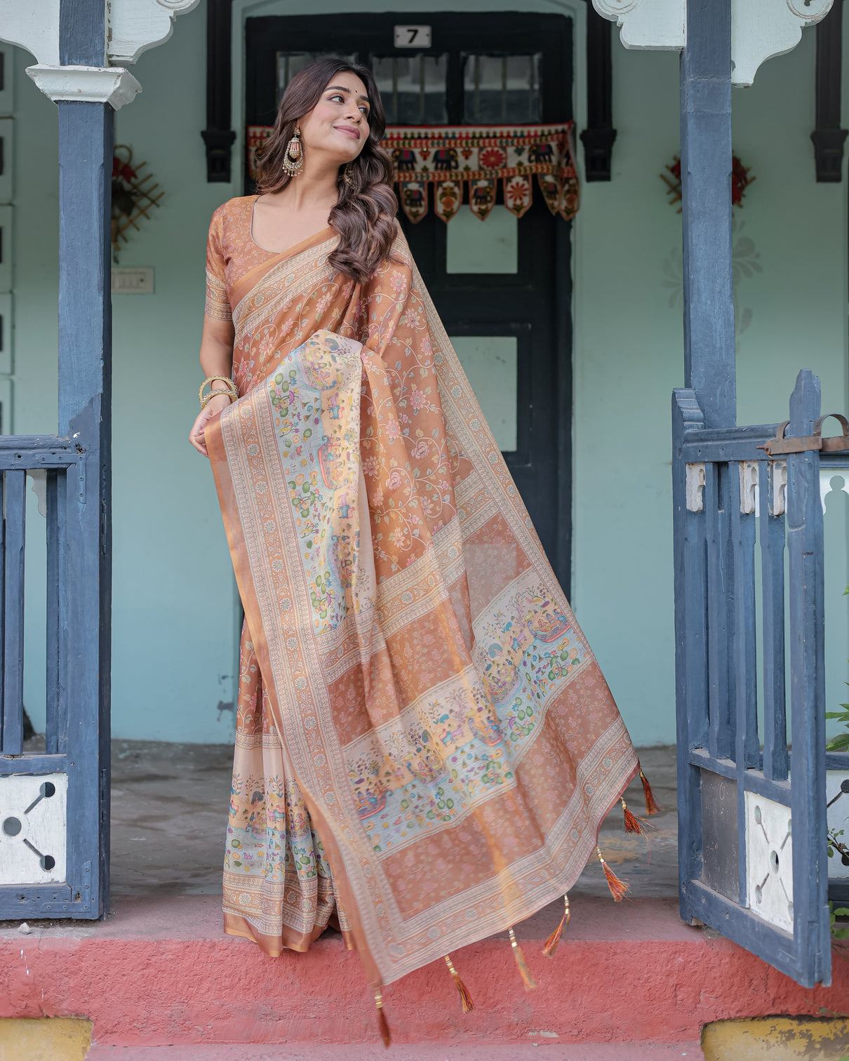 Burnt peach handloom cotton saree with floral buta design village scene pallu