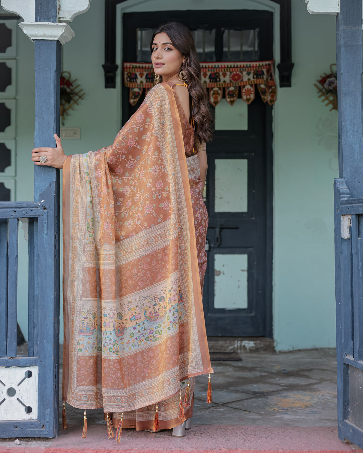 Burnt peach handloom cotton saree with floral buta design village scene pallu