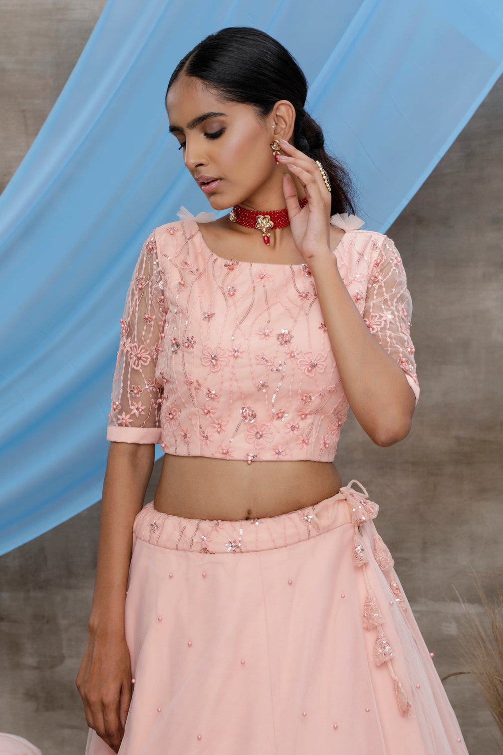 Peach Thread And Sequence Embroidered With All Over Pearl Rivet Stud Pasting Net Semi Stitched Bridal Lehenga